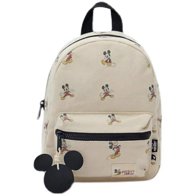 Sac a dos maternelle beige motifs Mickey, sur un fond blanc.